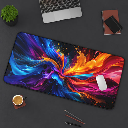 Colorful abstract mouse pad on a desk with laptop, coffee, and stationery items.