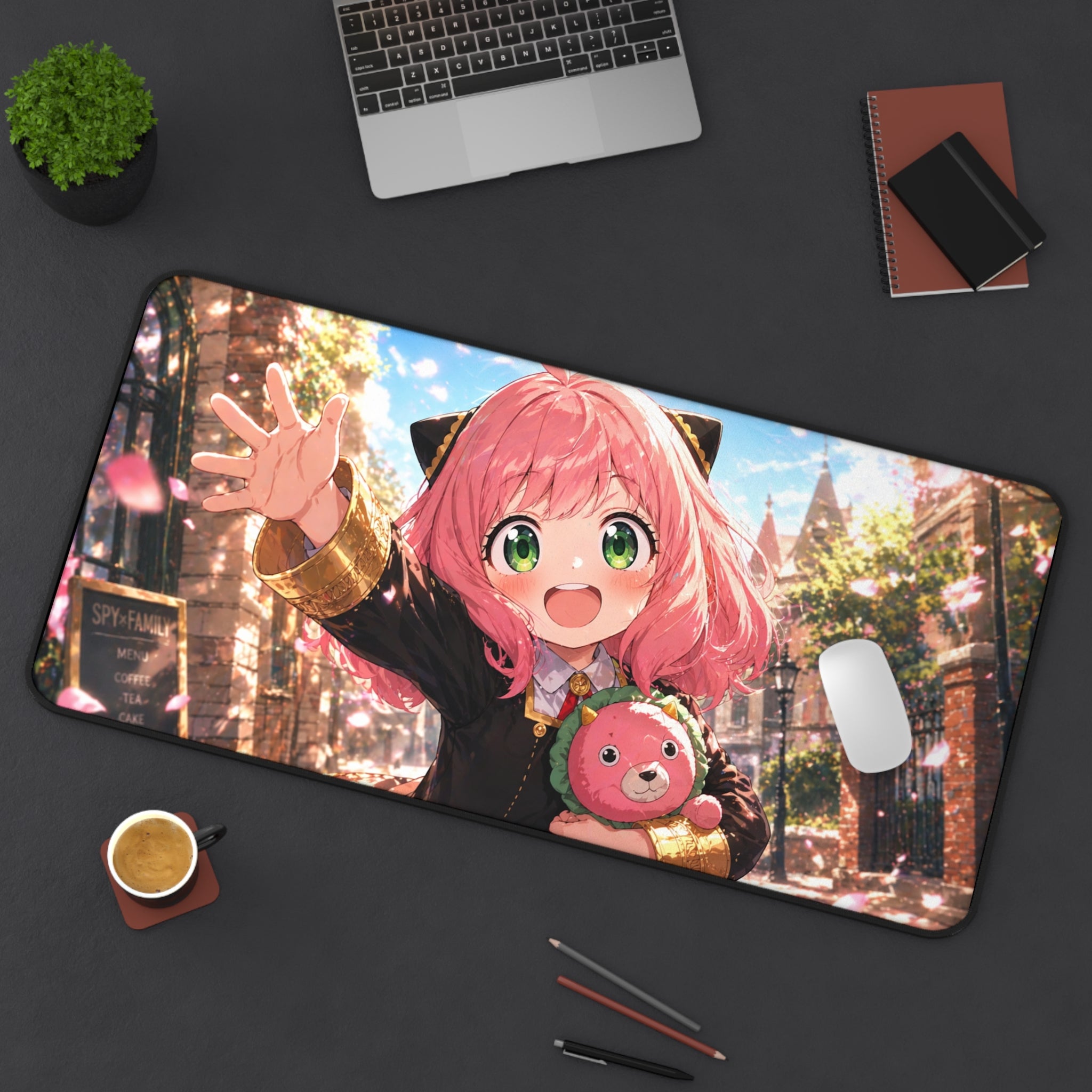 Large mouse pad with anime character design on a desk with laptop and stationery items.