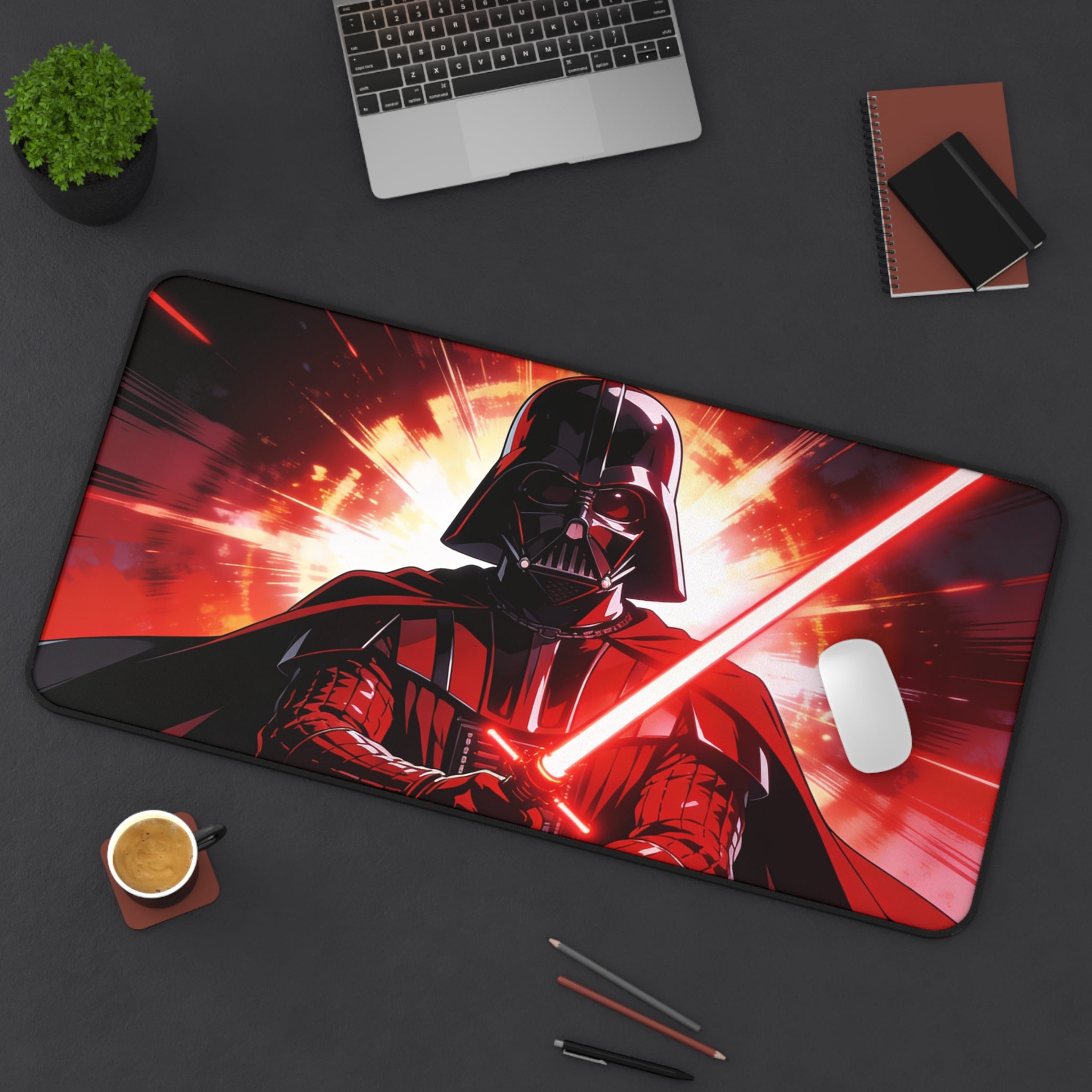 Darth Vader mouse pad on a desk with a laptop, coffee, and pens.