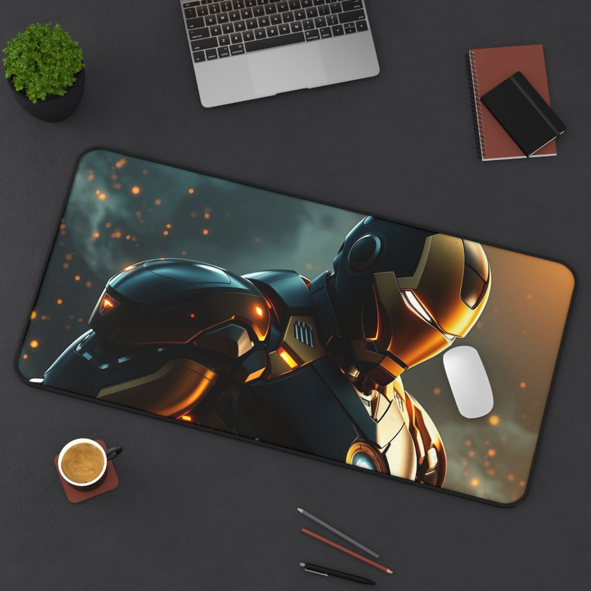 Desk setup with a large mouse pad featuring robot design, laptop, cup, and stationery items.
