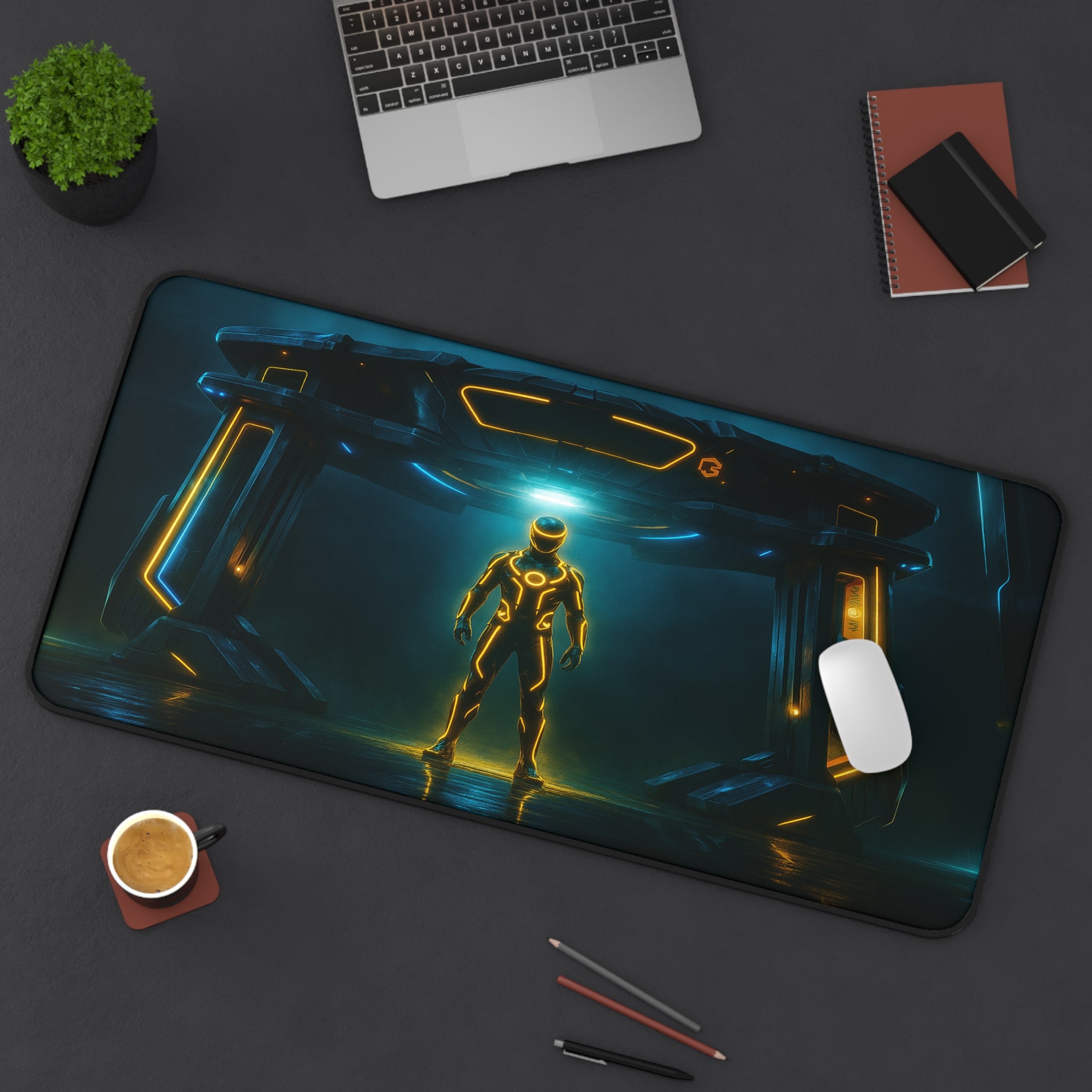Mouse pad with futuristic design on a desk with laptop, coffee, and stationery.