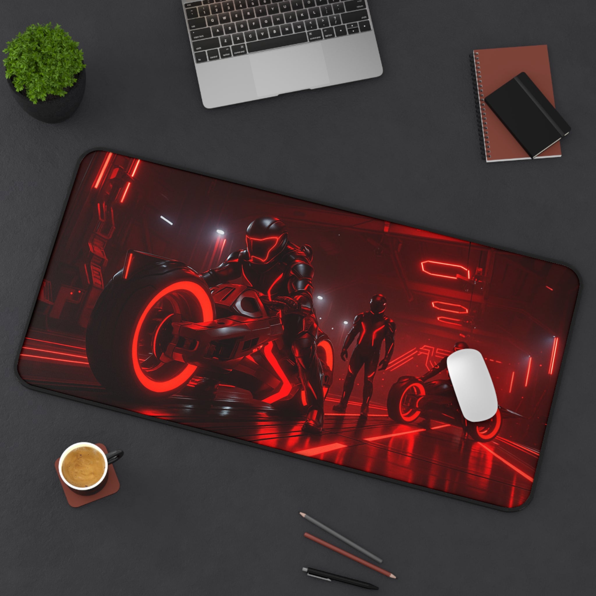 Gaming mouse pad with sci-fi design on a desk with laptop, cup, and pens.