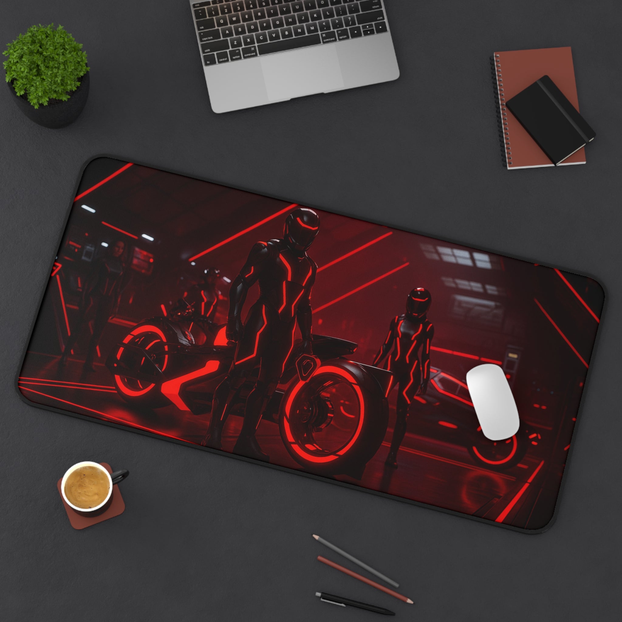 Mouse pad with motorcycle design on a desk with laptop, cup, and stationery.