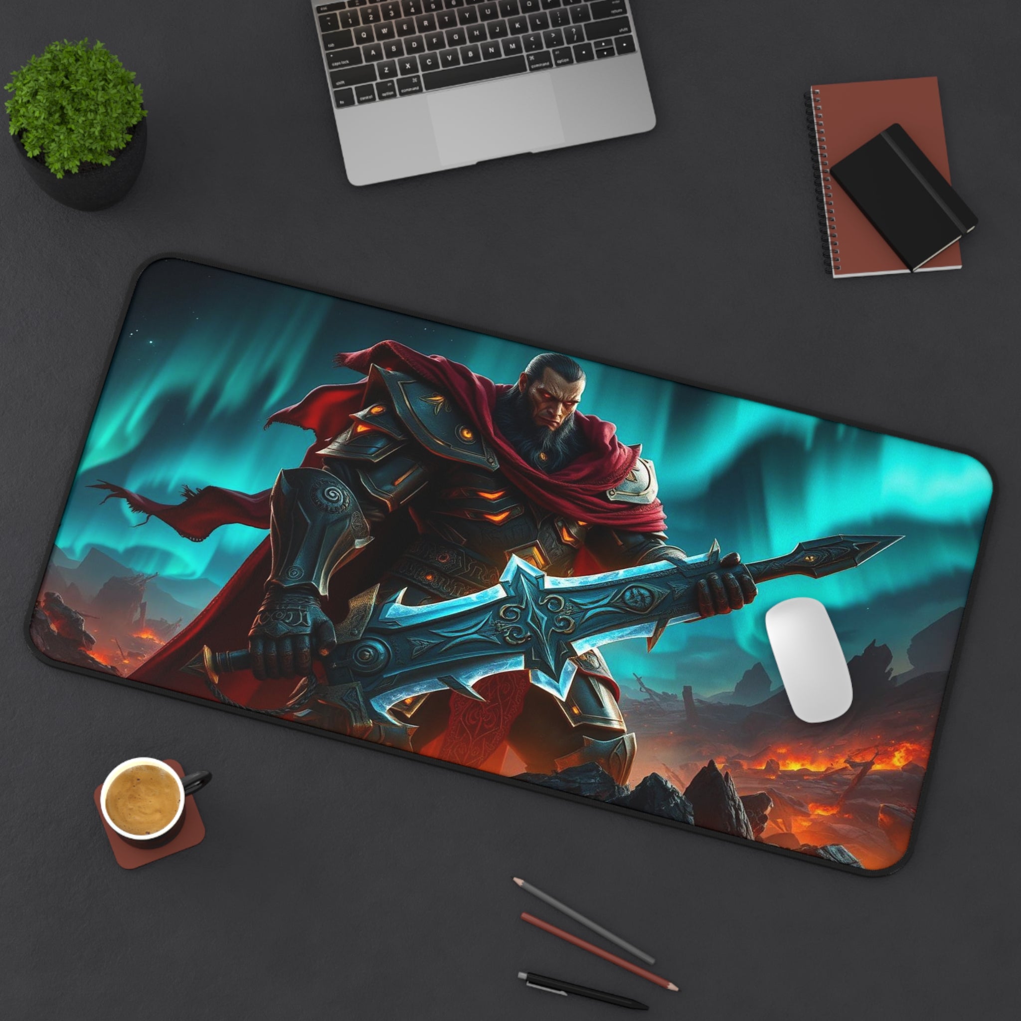 Mouse pad with warrior design on a desk with laptop, cup, and stationery.